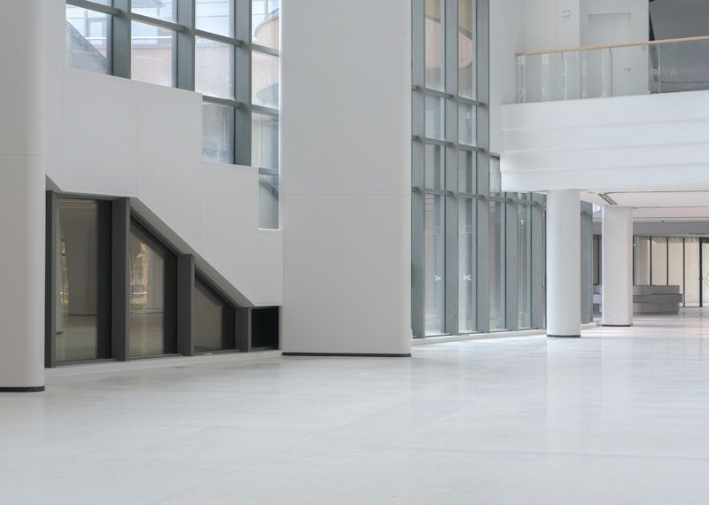 Modern white interior with large windows and columns